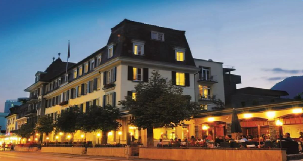 Modern exterior of Hotel Krebs Interlaken, one of the best hotels in Interlaken, showcasing its stylish architecture and mountain views.