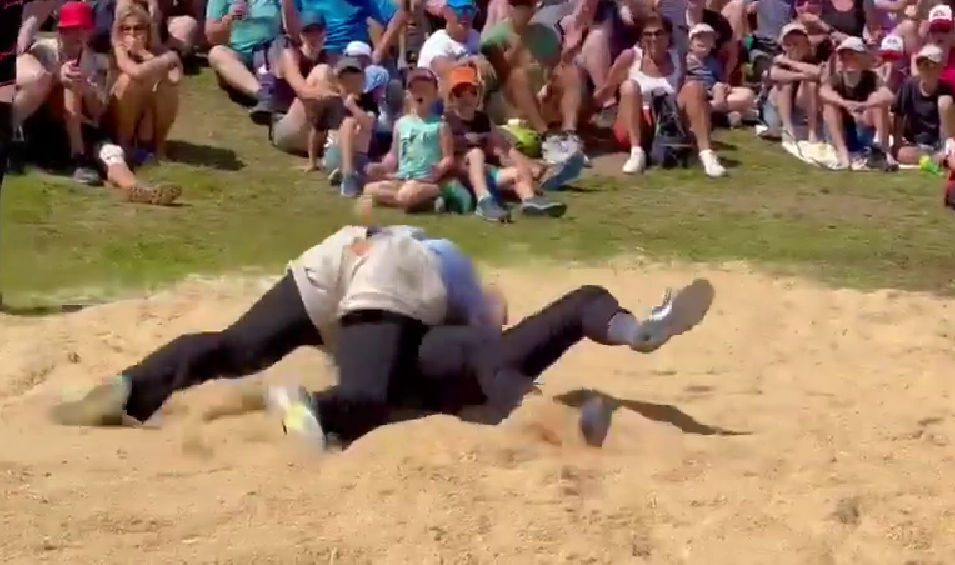 Schwingen wrestling match in Switzerland, with two wrestlers competing in a sawdust ring – a true example of funny Swiss traditions.