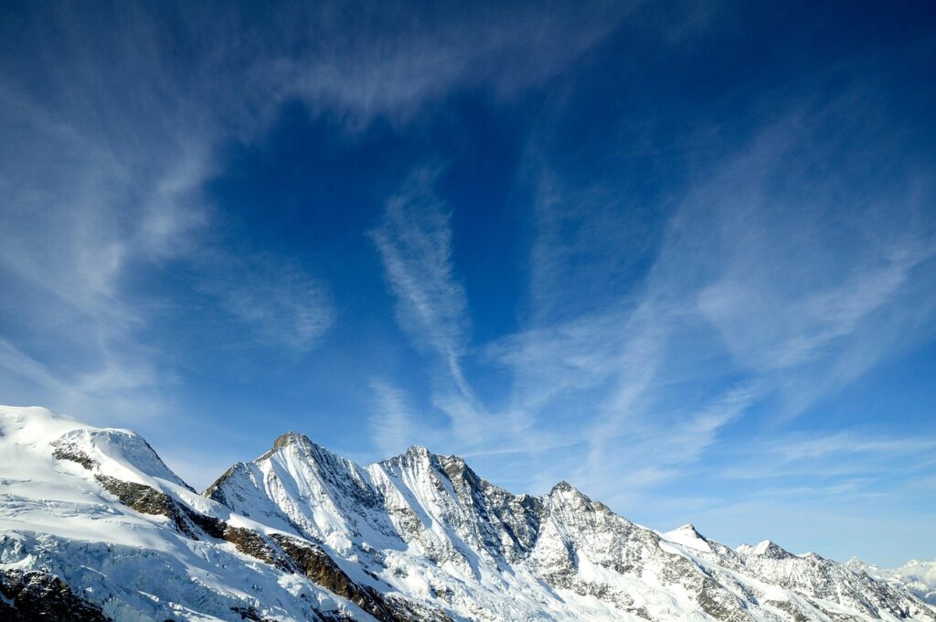 Snow-covered mountain peaks surrounding the peaceful alpine village of Saas-Fee.