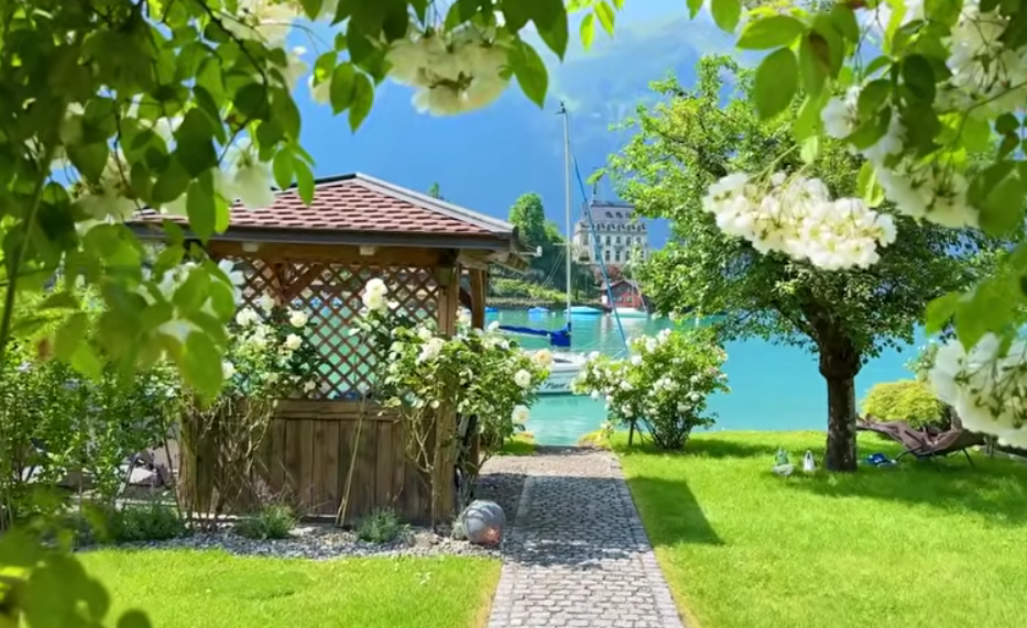 Sunny summer day in Iseltwald with turquoise Lake Brienz, perfect for kayaking and boat trips.