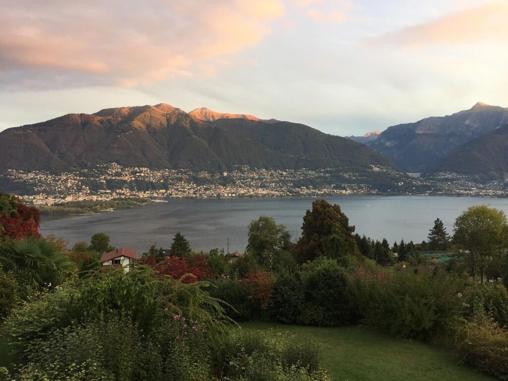 Lake Maggiore, surrounded by lush gardens, charming towns, and majestic mountains, offering one of the best lakeside walks in Switzerland.