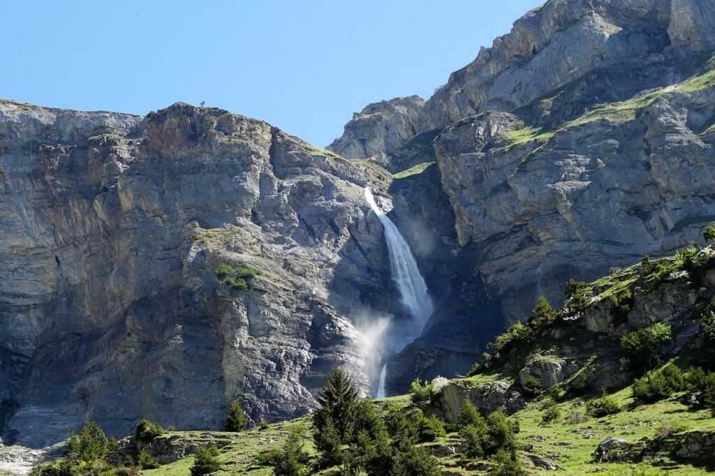 Scenic waterfall surrounded by alpine forest in Graubünden