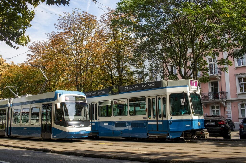 Two iconic blue trams passing through Zürich’s city center