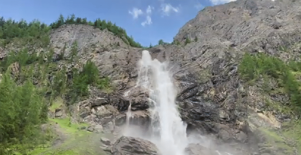 Powerful flow of Engstligen Falls near Adelboden, a stunning example of hidden waterfalls in Switzerland, framed by rocky cliffs and alpine meadows.