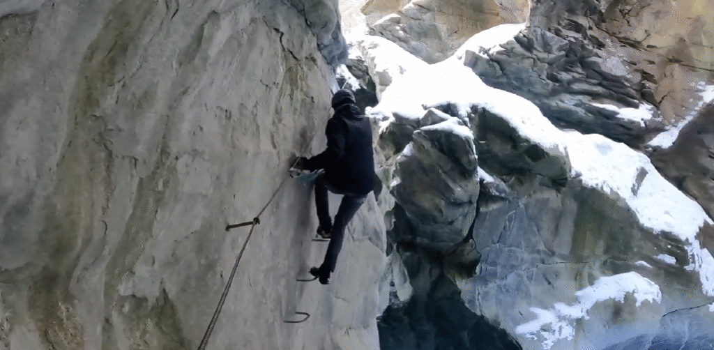 Climber ascending a rocky alpine route in Zermatt.