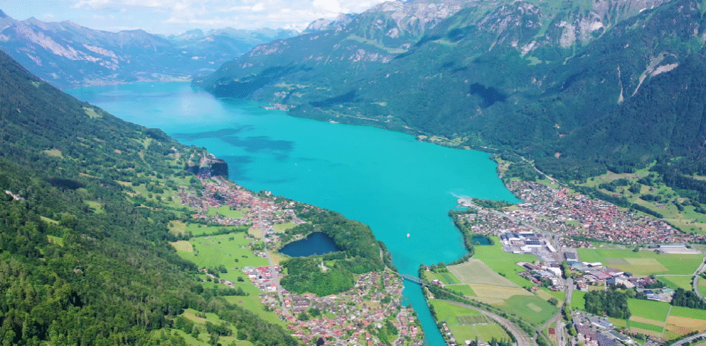 Aerial view of Interlaken, Switzerland, nestled between Lake Thun and Lake Brienz with the Alps in the background.