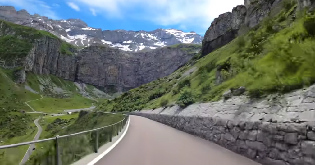 Motorcycle route through Klausen Pass in Switzerland, one of the most scenic motorcycle routes in Switzerland, with tight switchbacks, mountain meadows, and panoramic alpine views.
