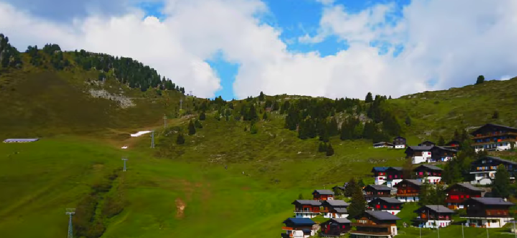 A scenic view of Riederalp, one of the charming Switzerland car-free villages, situated on a sunny terrace overlooking the Rhone Valley.