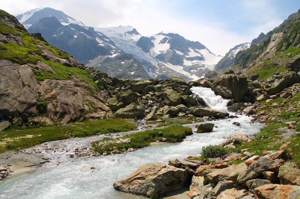 Crystal-clear river flowing through Swiss mountain valley